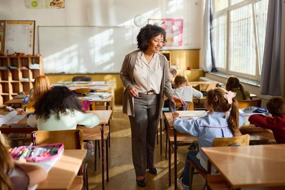 A woman teaching a classroom of children