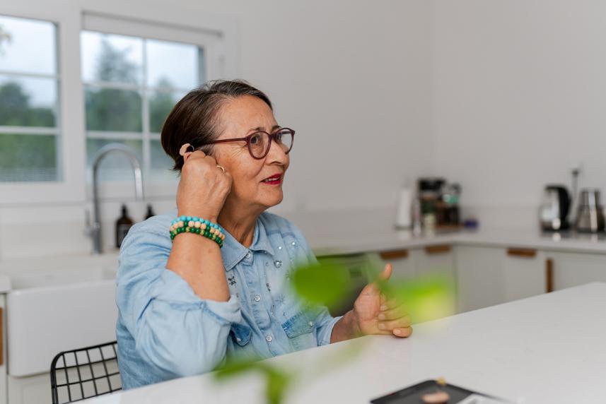 Woman adjusting her hearing aid